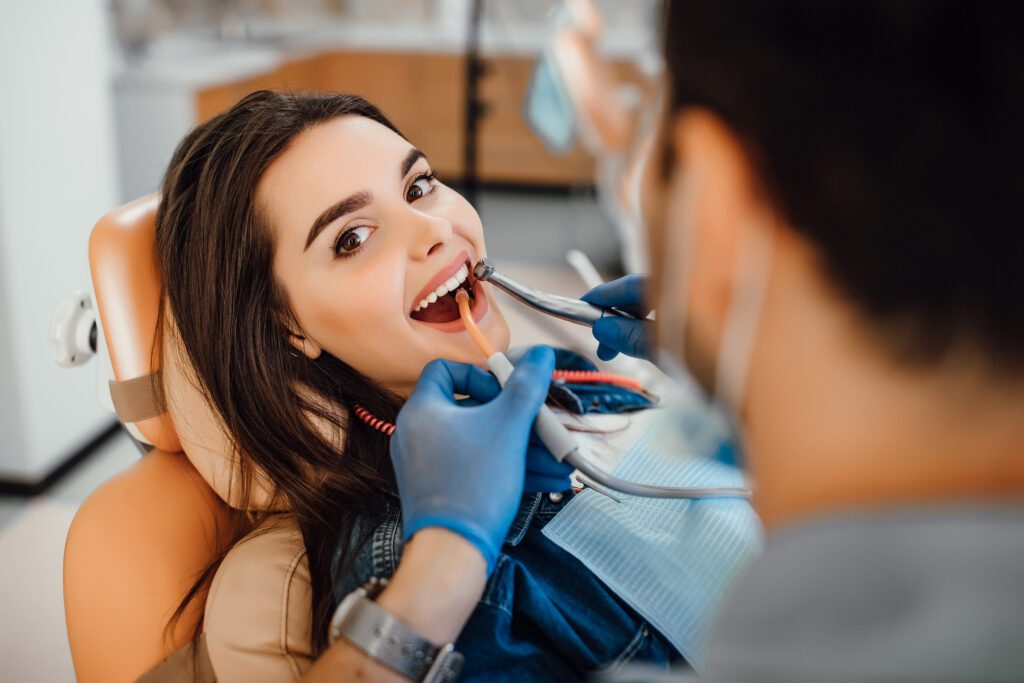 young-female-patient-visiting-dentist-office | Dental Krafts